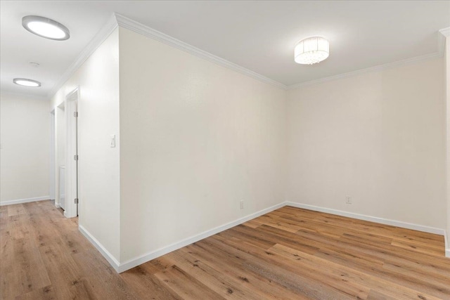 unfurnished room with light wood-type flooring and crown molding