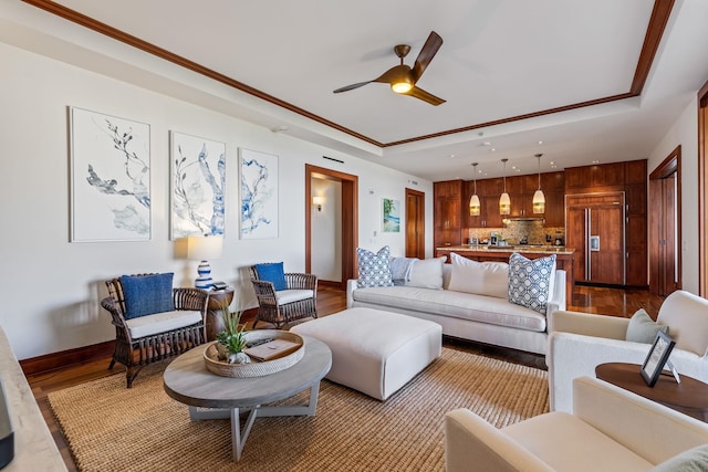 living room featuring light hardwood / wood-style flooring, ceiling fan, and crown molding