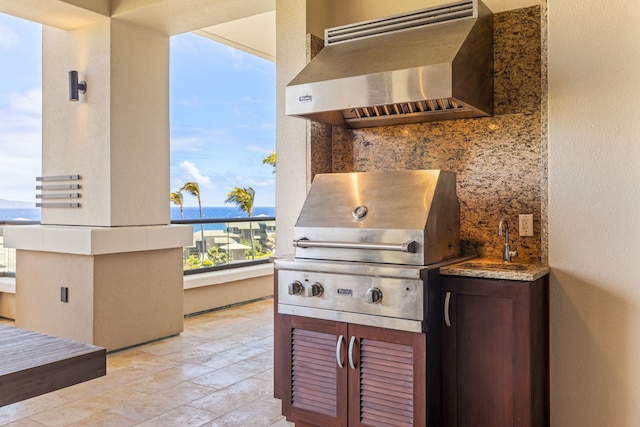 view of patio featuring a balcony, a water view, and area for grilling