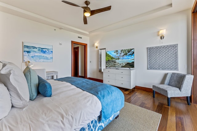 bedroom with ceiling fan and dark hardwood / wood-style flooring