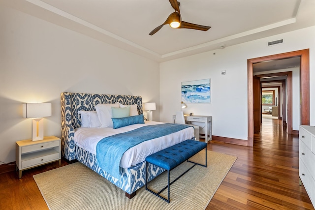 bedroom with dark hardwood / wood-style floors and ceiling fan