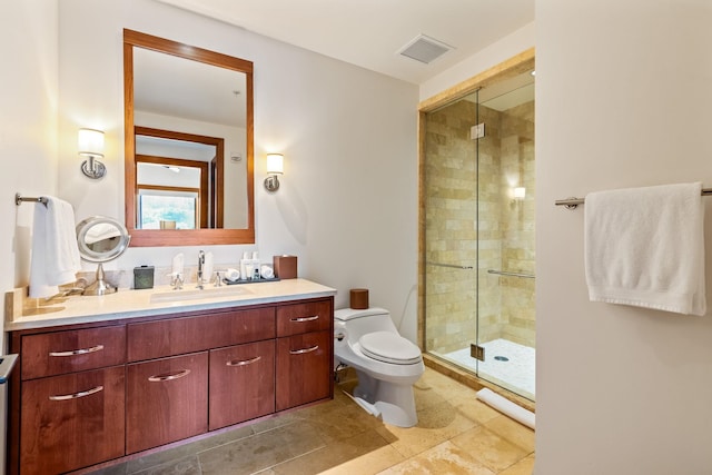 bathroom with tile patterned flooring, a shower with shower door, vanity, and toilet