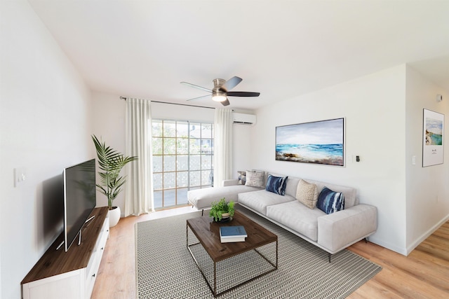 living room featuring a wall mounted AC, light wood-type flooring, and ceiling fan