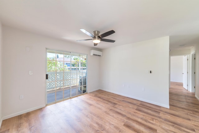 empty room featuring a wall mounted AC, ceiling fan, and light wood-type flooring