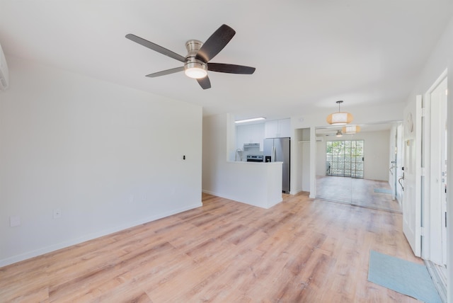 unfurnished living room with ceiling fan and light hardwood / wood-style flooring