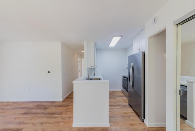 kitchen featuring light hardwood / wood-style floors, white cabinetry, sink, and appliances with stainless steel finishes