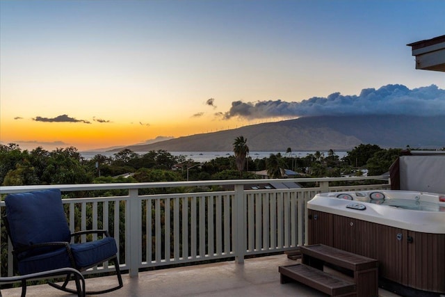 exterior space featuring a mountain view and a hot tub