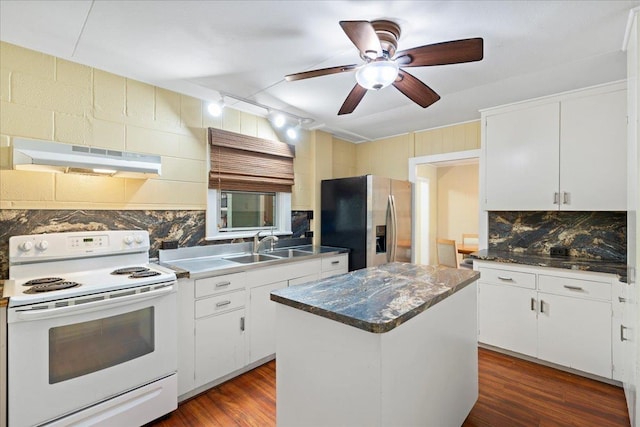 kitchen with wood finished floors, stainless steel fridge, under cabinet range hood, white electric range, and tasteful backsplash