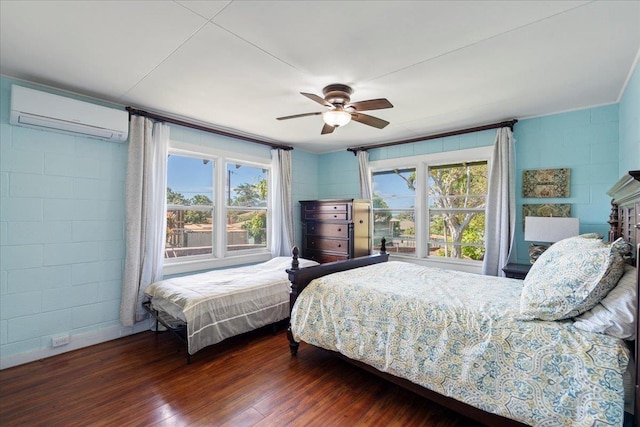 bedroom with multiple windows, wood finished floors, a wall mounted air conditioner, and ceiling fan