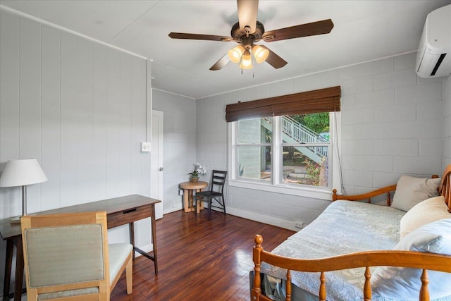 living room featuring concrete block wall, dark wood-type flooring, a ceiling fan, and a wall mounted AC