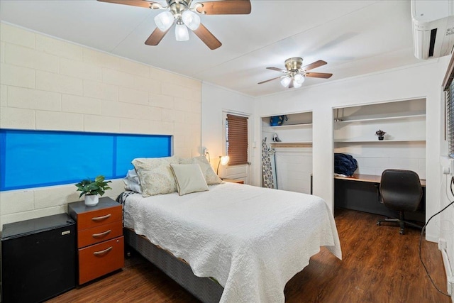 bedroom featuring dark wood-style floors, built in desk, and ceiling fan