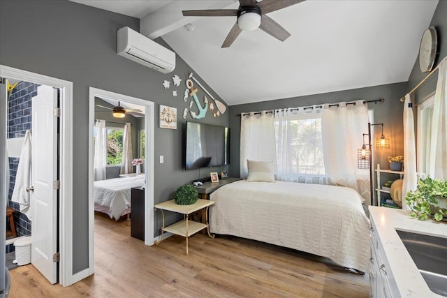 bedroom with vaulted ceiling with beams, a ceiling fan, light wood-type flooring, and a wall mounted AC