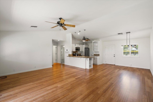 23 Poinciana Rd, Lahaina, HI 96761 - unfurnished living room with ceiling fan, lofted ceiling, light wood finished floors, a sink, and baseboards