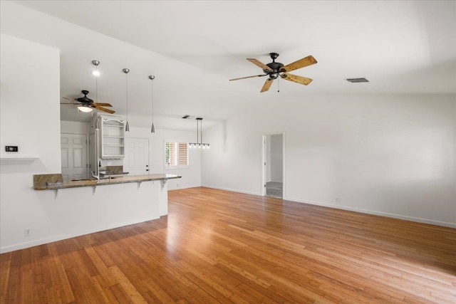 23 Poinciana Rd, Lahaina, HI 96761 - unfurnished living room with a ceiling fan, light wood-type flooring, lofted ceiling, baseboards, and a sink