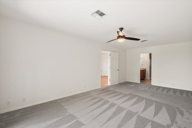 23 Poinciana Rd, Lahaina, HI 96761 - unfurnished bedroom featuring light colored carpet, baseboards, connected bathroom, and a ceiling fan