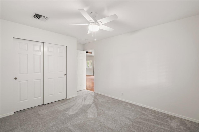 23 Poinciana Rd, Lahaina, HI 96761 - unfurnished bedroom with carpet, a closet, baseboards, and a ceiling fan