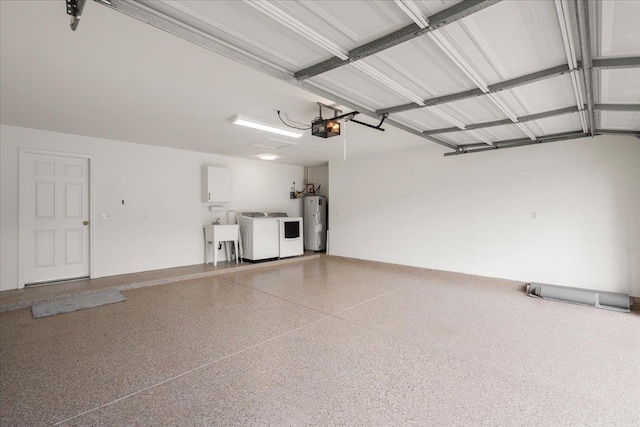 23 Poinciana Rd, Lahaina, HI 96761 - garage with water heater, washer and dryer, a garage door opener, and a sink