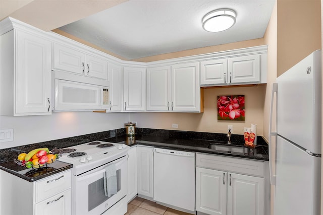 kitchen featuring white cabinetry, sink, white appliances, and light tile patterned floors