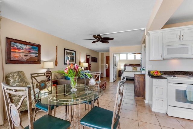 tiled dining area featuring ceiling fan