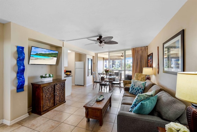 living room with light tile patterned floors, a wall of windows, and ceiling fan