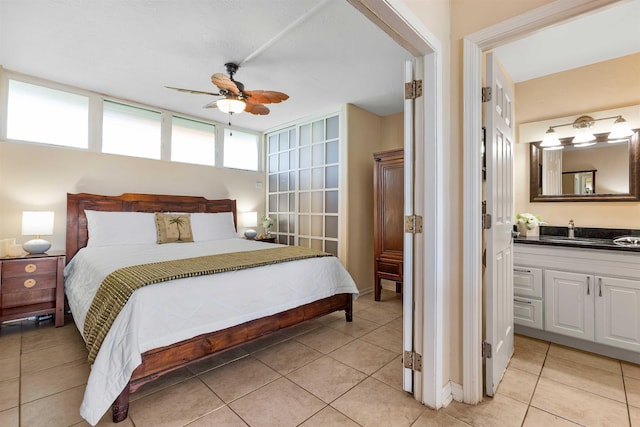 tiled bedroom featuring ceiling fan and sink