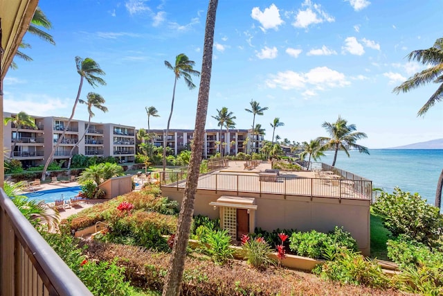 exterior space with a water view and a community pool