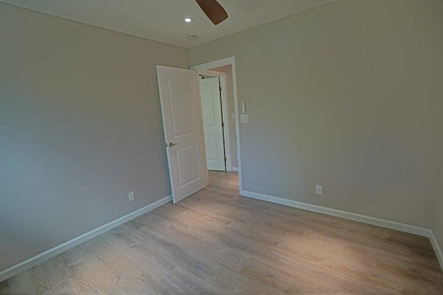 unfurnished room with light wood-type flooring and ceiling fan