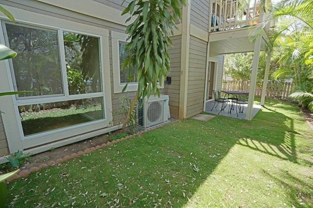 view of yard featuring ac unit and a balcony