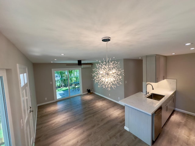 kitchen featuring sink, dishwasher, dark hardwood / wood-style flooring, and light stone counters