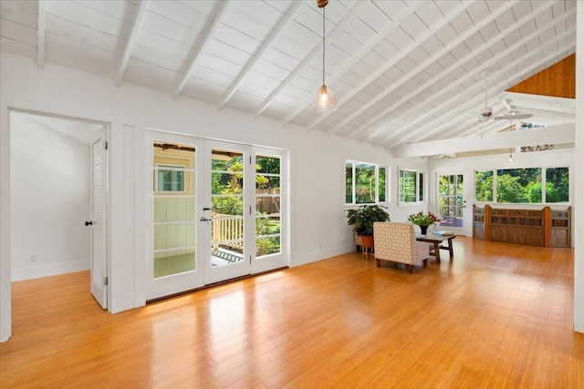 unfurnished sunroom with a ceiling fan, vaulted ceiling with beams, and french doors