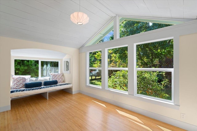 unfurnished sunroom featuring vaulted ceiling