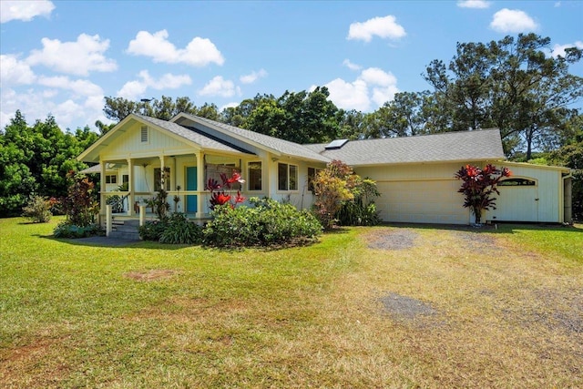 ranch-style house featuring a front yard, a garage, covered porch, and driveway