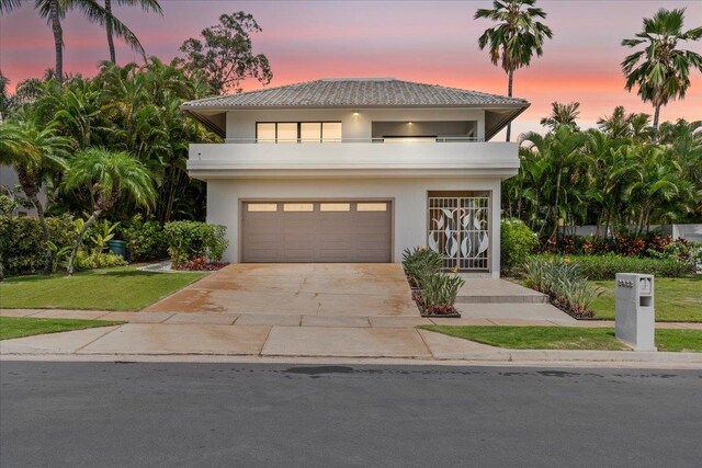 view of front of property with a balcony and a garage