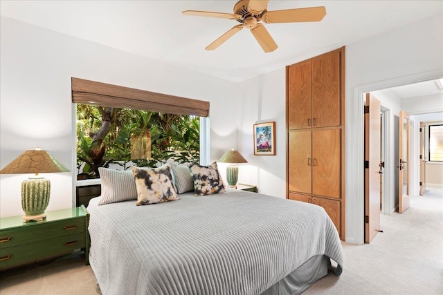 bedroom featuring ceiling fan and light colored carpet