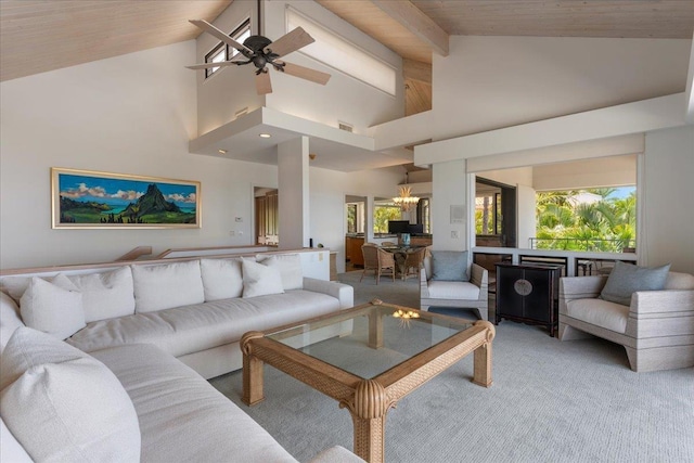 carpeted living room with beam ceiling, ceiling fan with notable chandelier, high vaulted ceiling, and a healthy amount of sunlight