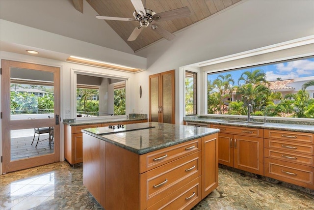 kitchen with a center island, sink, vaulted ceiling, black electric cooktop, and wood ceiling