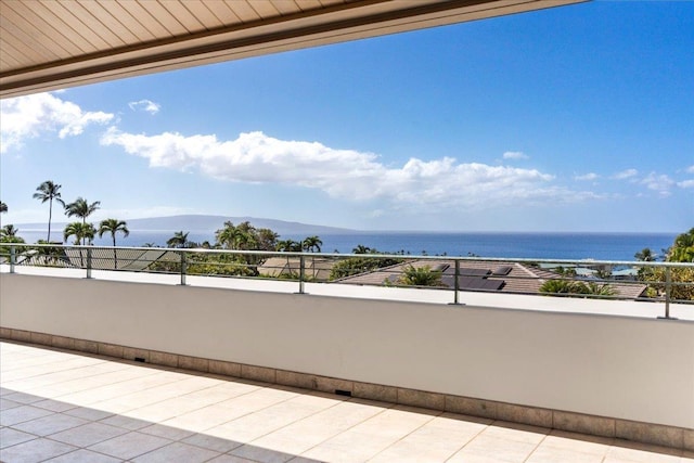 view of patio with a water view and a balcony