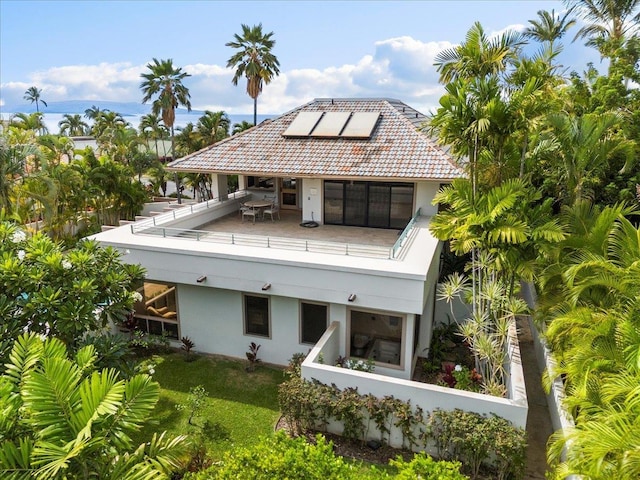 back of house with solar panels