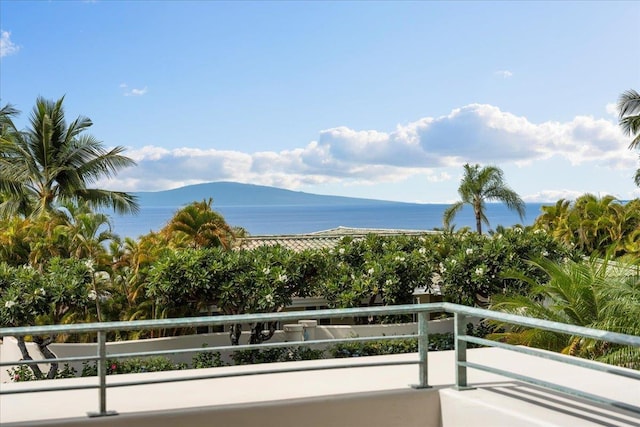 balcony with a water and mountain view