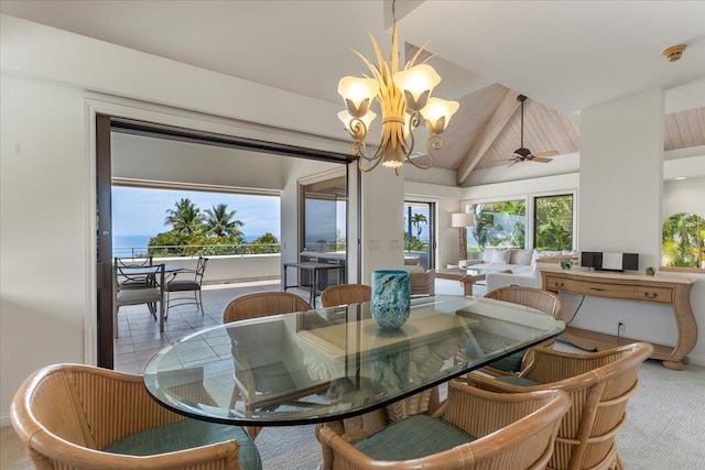 carpeted dining space featuring lofted ceiling with beams, a water view, and ceiling fan with notable chandelier