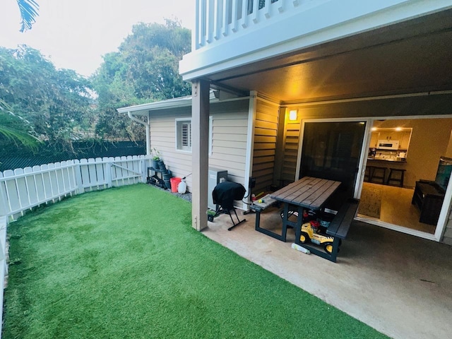 view of yard with a patio area and a balcony