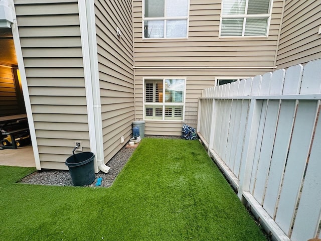 view of side of home featuring a yard