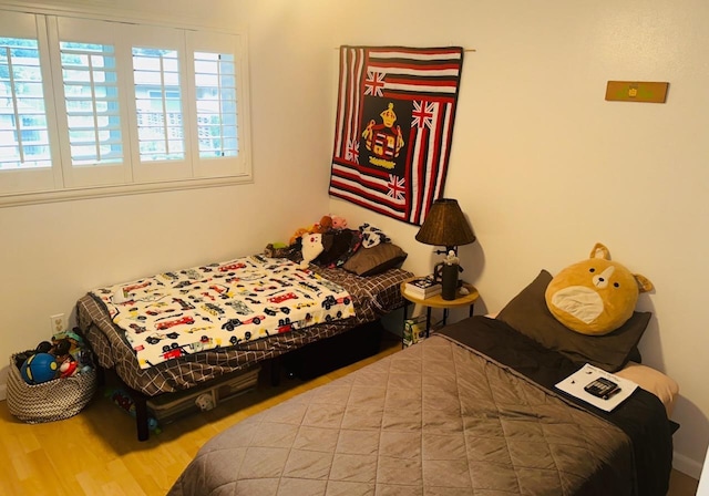 bedroom with hardwood / wood-style flooring