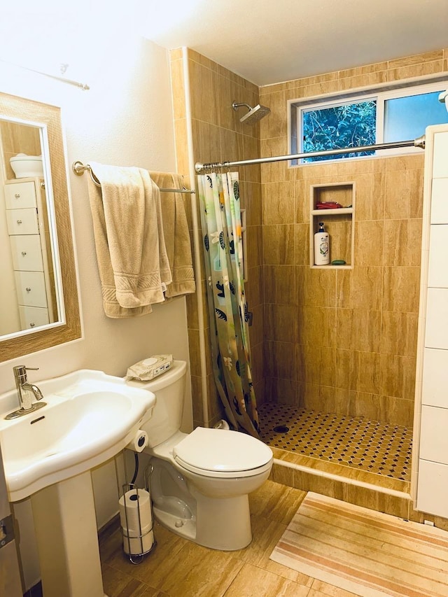 bathroom with hardwood / wood-style flooring, toilet, and a shower with shower curtain