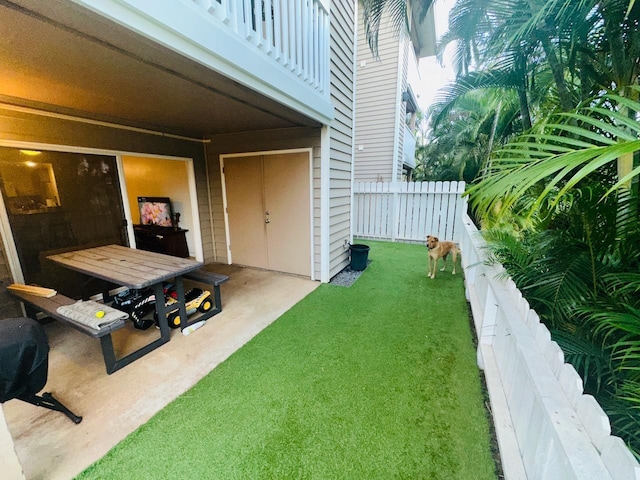 view of yard with a patio and a balcony