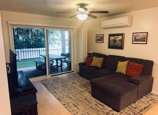 living room with wood-type flooring, an AC wall unit, and ceiling fan