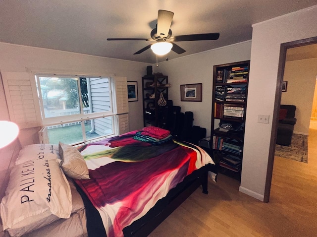 bedroom with ceiling fan and light wood-type flooring