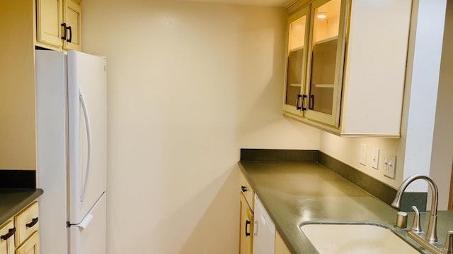 kitchen featuring white refrigerator and sink