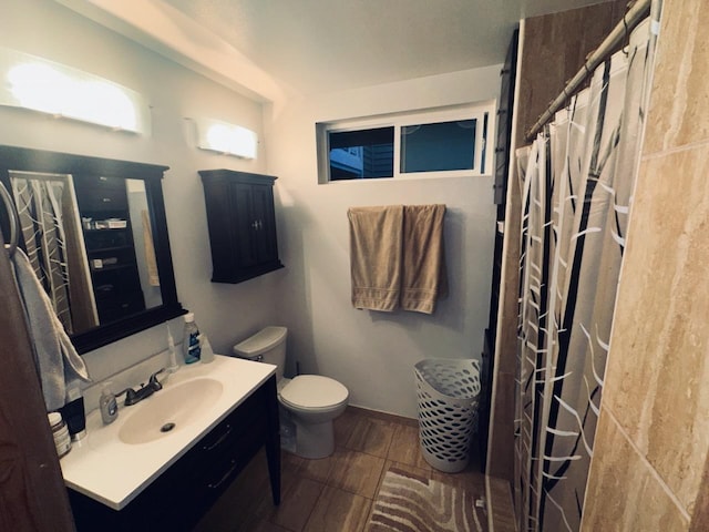 bathroom with vanity, toilet, and walk in shower