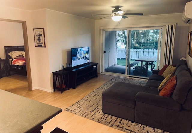 living room with an AC wall unit, hardwood / wood-style floors, and ceiling fan